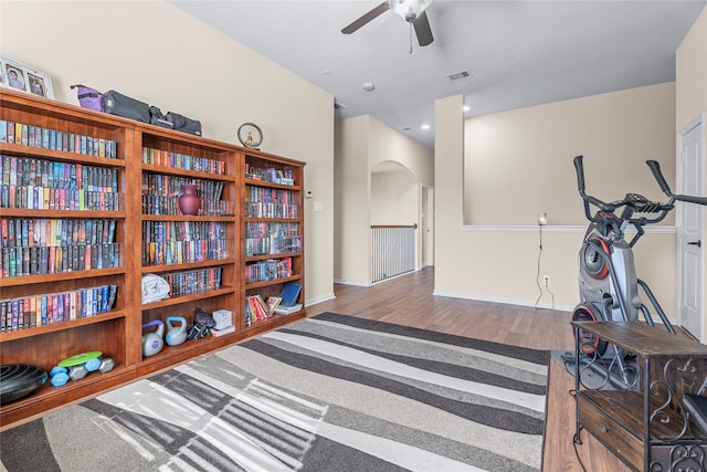 living area with ceiling fan and hardwood / wood-style flooring