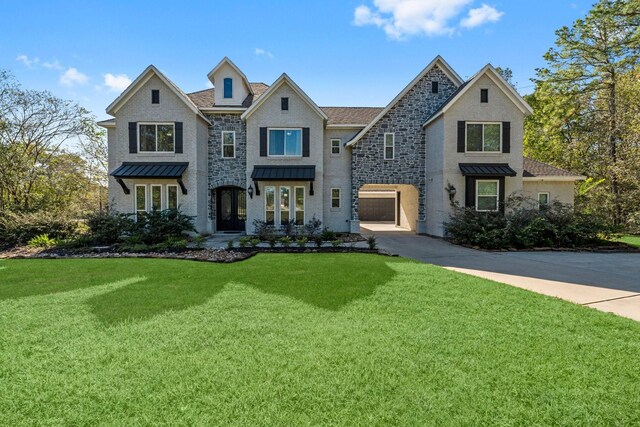 view of front of house with a garage and a front lawn