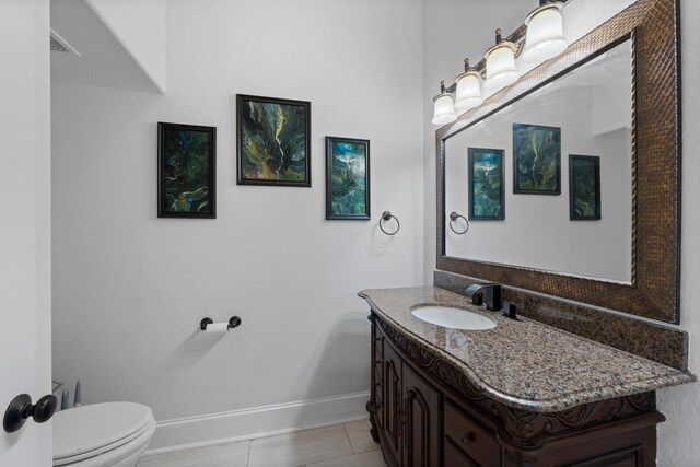 bathroom featuring vanity, toilet, and tile patterned floors