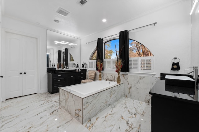 bathroom with vanity, tiled tub, and ornamental molding