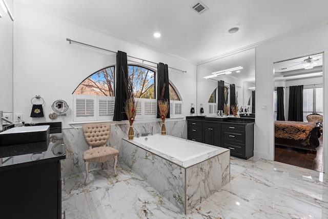 bathroom with vanity, ceiling fan, tiled tub, and ornamental molding