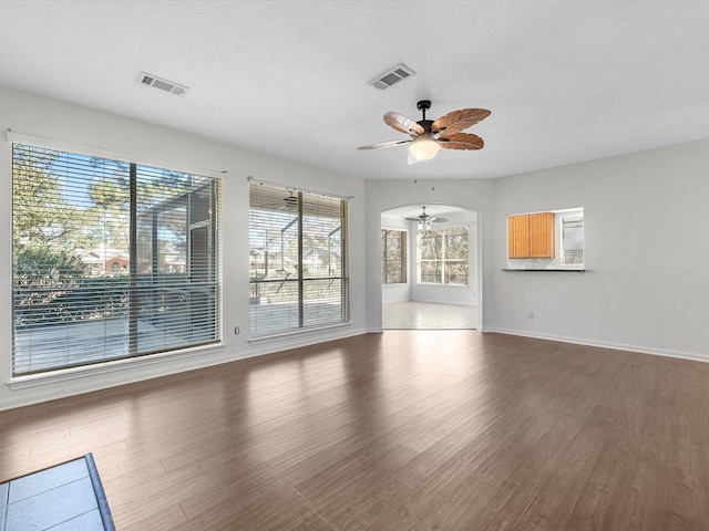 8311 Vaulted Pine Dr, Humble, TX 77346 - unfurnished living room featuring a ceiling fan, wood finished floors, and baseboards