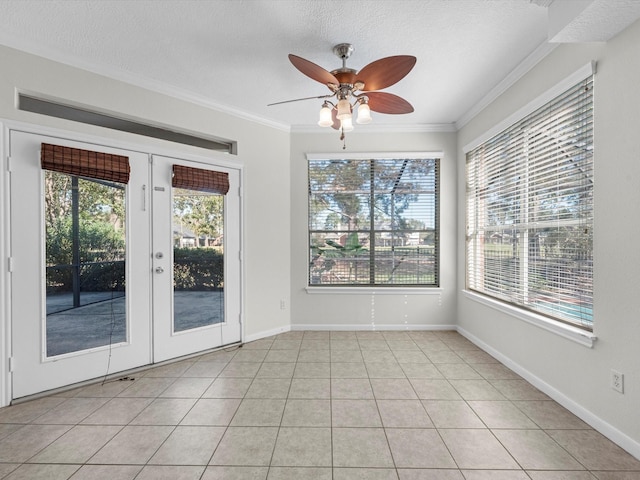 8311 Vaulted Pine Dr, Humble, TX 77346 - empty room with a ceiling fan, ornamental molding, a textured ceiling, baseboards, and french doors