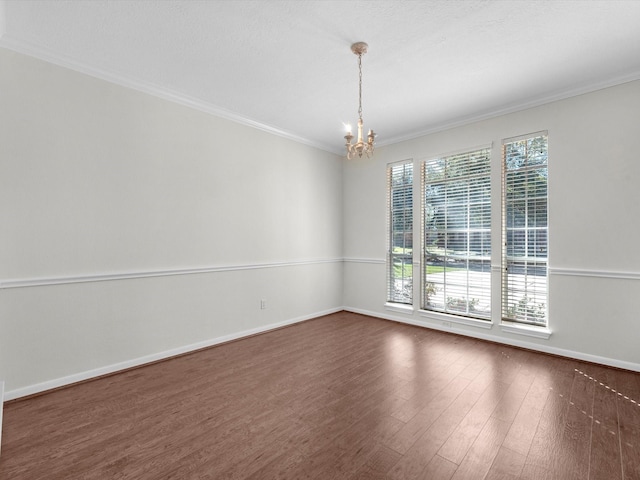 8311 Vaulted Pine Dr, Humble, TX 77346 - empty room with dark wood-style floors, a chandelier, baseboards, and ornamental molding