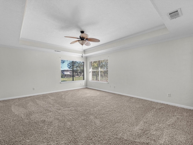 8311 Vaulted Pine Dr, Humble, TX 77346 - empty room featuring a tray ceiling, a ceiling fan, crown molding, a textured ceiling, and carpet floors