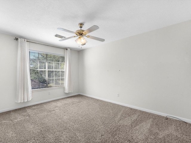 8311 Vaulted Pine Dr, Humble, TX 77346 - spare room with carpet flooring, baseboards, ceiling fan, and a textured ceiling