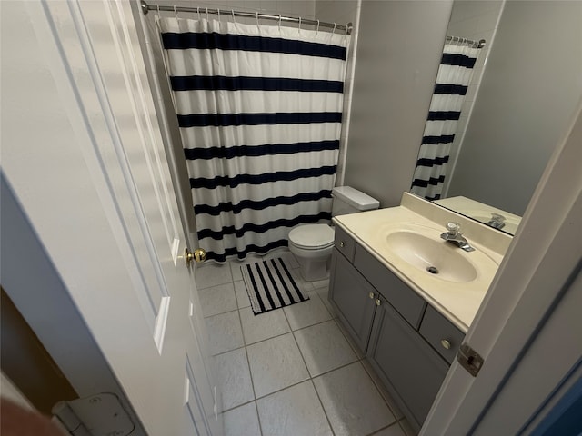 bathroom with tile patterned floors, vanity, and toilet