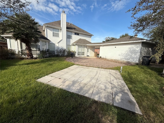 back of house with a yard and a patio