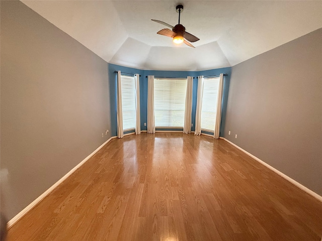 unfurnished room with ceiling fan, light hardwood / wood-style floors, and lofted ceiling