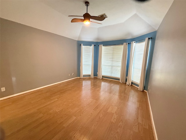 empty room featuring ceiling fan, light hardwood / wood-style floors, and lofted ceiling