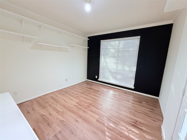 spare room with light hardwood / wood-style flooring and ornamental molding