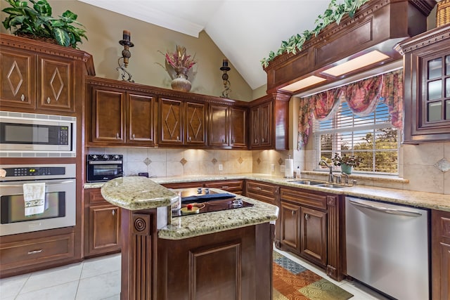 kitchen with black appliances, sink, vaulted ceiling, decorative backsplash, and a kitchen island