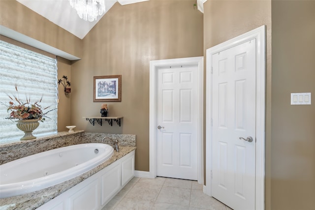 bathroom with a bathing tub and a chandelier