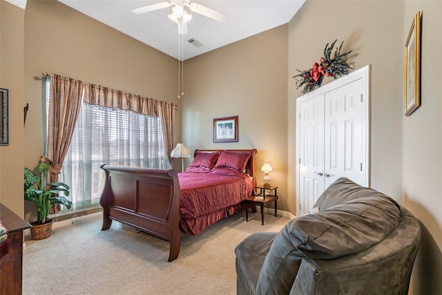 bedroom with ceiling fan, a closet, and carpet floors