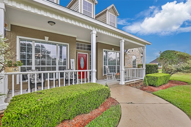 entrance to property featuring covered porch