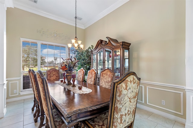 tiled dining area featuring crown molding and a chandelier