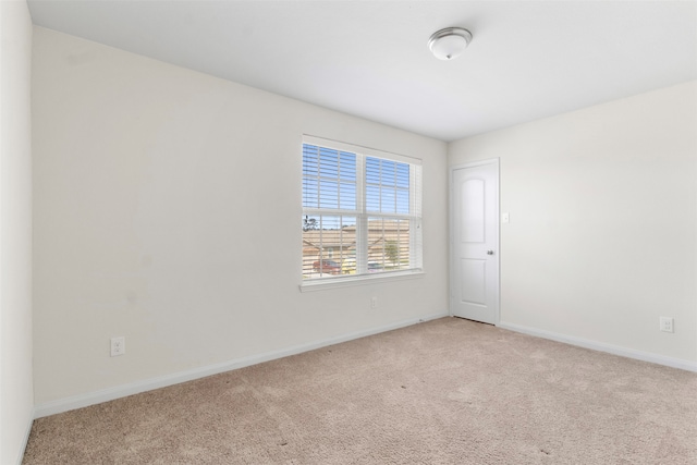 empty room featuring light colored carpet