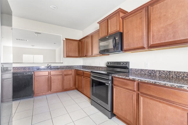 kitchen with black appliances, light tile patterned floors, sink, and dark stone counters