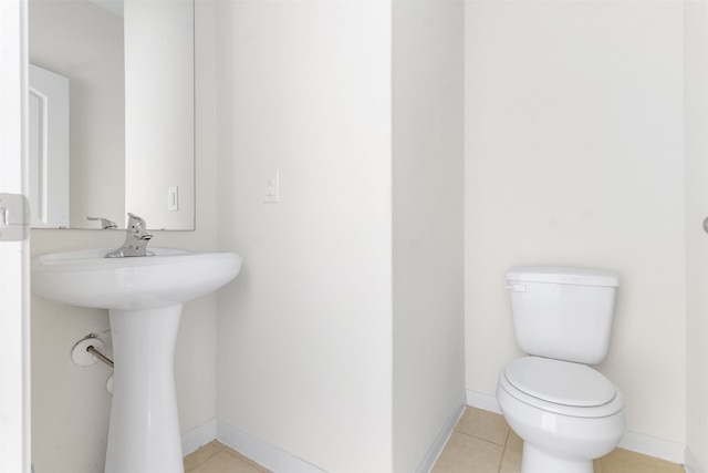 bathroom with tile patterned flooring and toilet