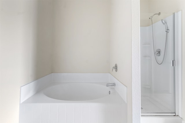 bathroom featuring separate shower and tub