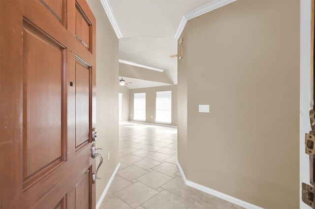 tiled foyer with ceiling fan and ornamental molding