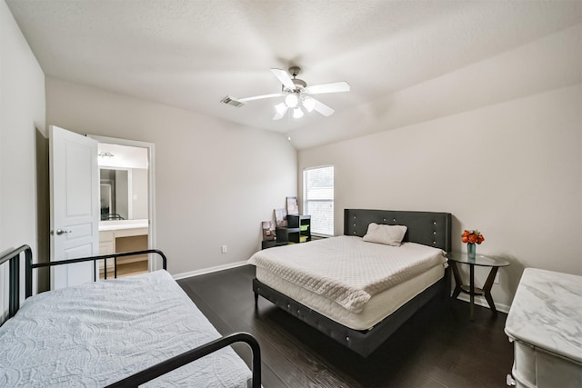 bedroom featuring dark hardwood / wood-style flooring, vaulted ceiling, ceiling fan, and connected bathroom