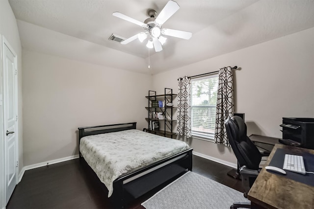 bedroom with ceiling fan and dark hardwood / wood-style floors