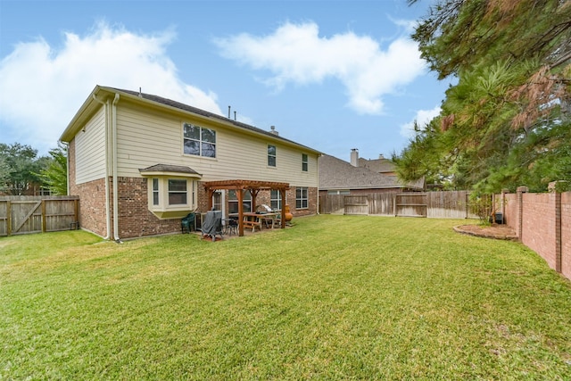 back of house with a pergola and a lawn