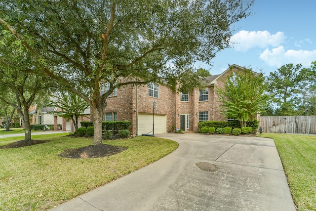 view of front of property featuring a front yard and a garage