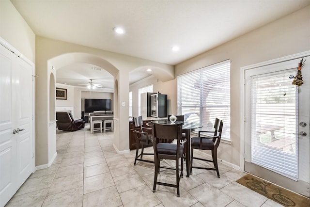 tiled dining area with ceiling fan