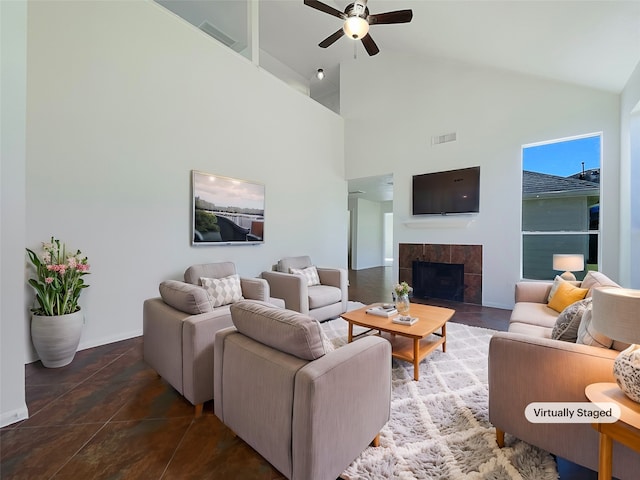 tiled living room with a fireplace, high vaulted ceiling, and ceiling fan