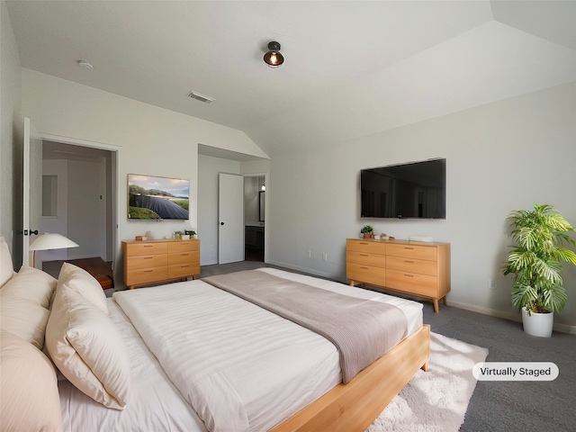 bedroom with dark carpet and vaulted ceiling