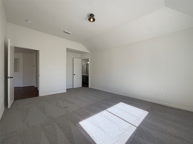 unfurnished bedroom featuring carpet and lofted ceiling