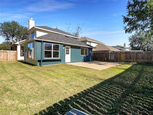 18131 Dusty Terrace Ln, Katy, TX 77449 - back of house featuring a yard, a fenced backyard, a patio, a chimney, and a shingled roof