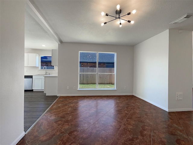18131 Dusty Terrace Ln, Katy, TX 77449 - unfurnished living room with a chandelier, visible vents, baseboards, and a sink