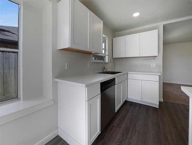 18131 Dusty Terrace Ln, Katy, TX 77449 - kitchen featuring white cabinetry, dishwasher, light countertops, a sink, and dark wood-style floors