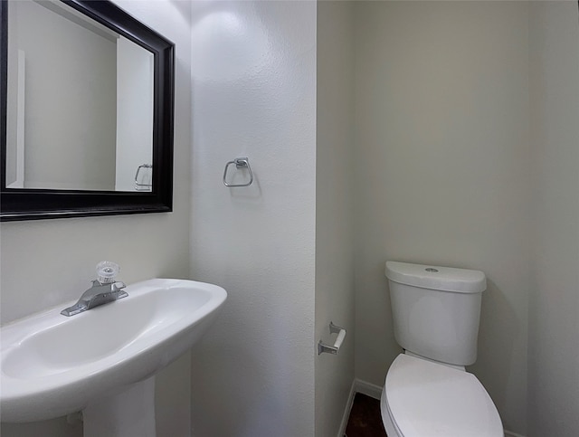 bathroom featuring toilet and sink