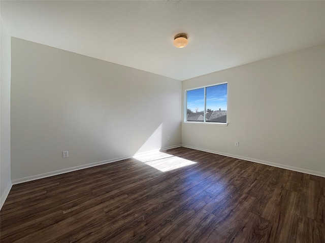 empty room featuring dark hardwood / wood-style flooring