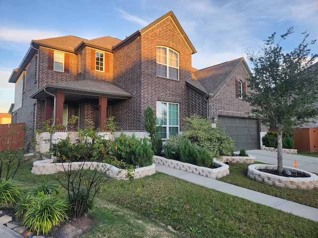 view of front of property featuring a front yard and a garage