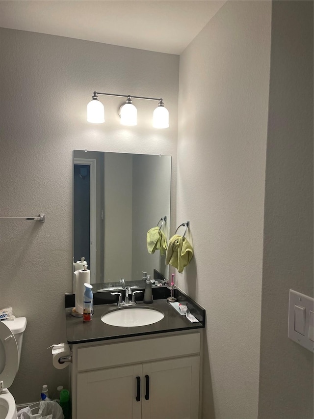 bathroom featuring vanity and toilet