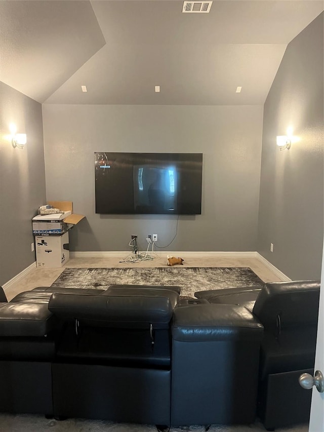 home theater room featuring vaulted ceiling