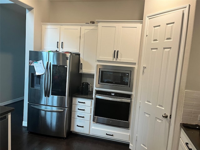 kitchen featuring white cabinetry, dark wood-type flooring, and stainless steel appliances