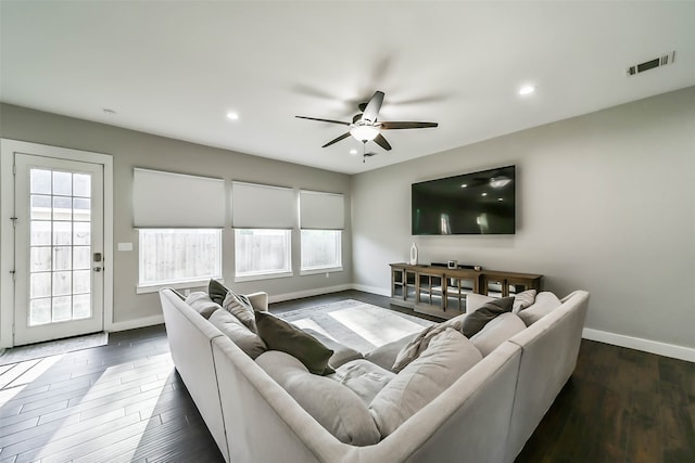 living room featuring dark hardwood / wood-style flooring, plenty of natural light, and ceiling fan