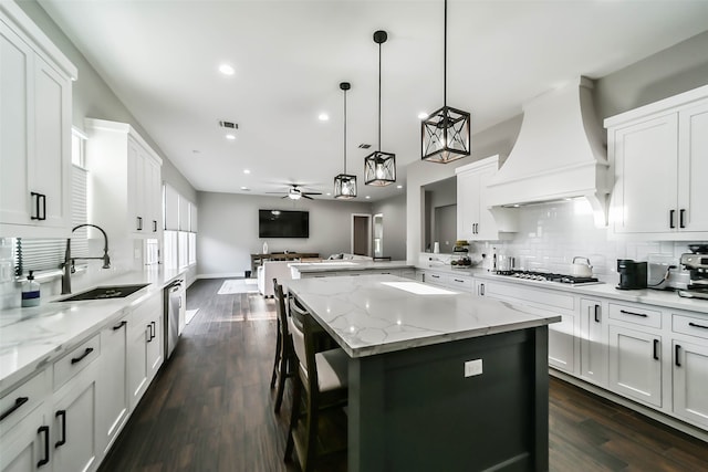 kitchen with premium range hood, sink, ceiling fan, dark hardwood / wood-style floors, and white cabinetry