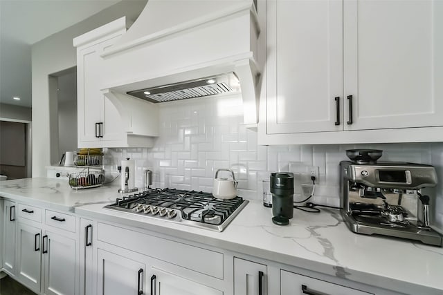 kitchen with white cabinets, stainless steel gas cooktop, and custom exhaust hood