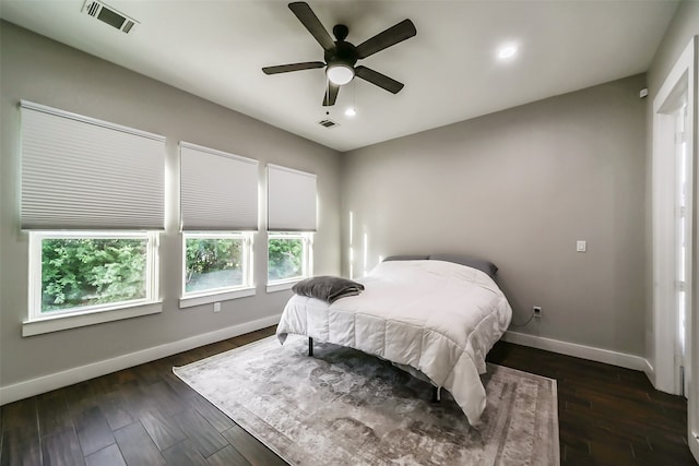 bedroom with ceiling fan and dark hardwood / wood-style flooring