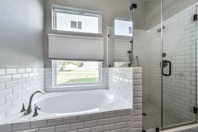 bathroom featuring independent shower and bath