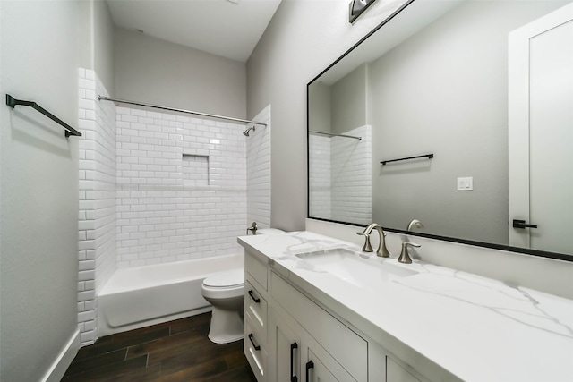 full bathroom with hardwood / wood-style flooring, vanity, toilet, and tiled shower / bath