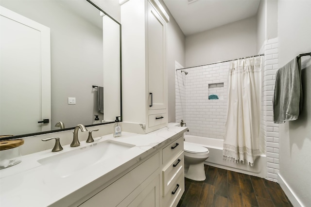 full bathroom with hardwood / wood-style floors, vanity, shower / bath combination with curtain, and toilet