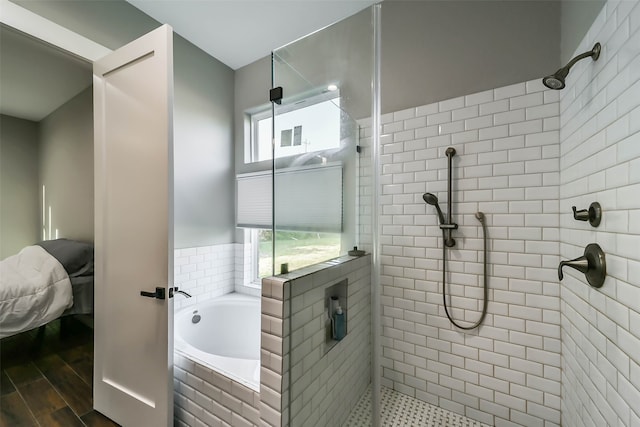 bathroom with separate shower and tub and hardwood / wood-style flooring